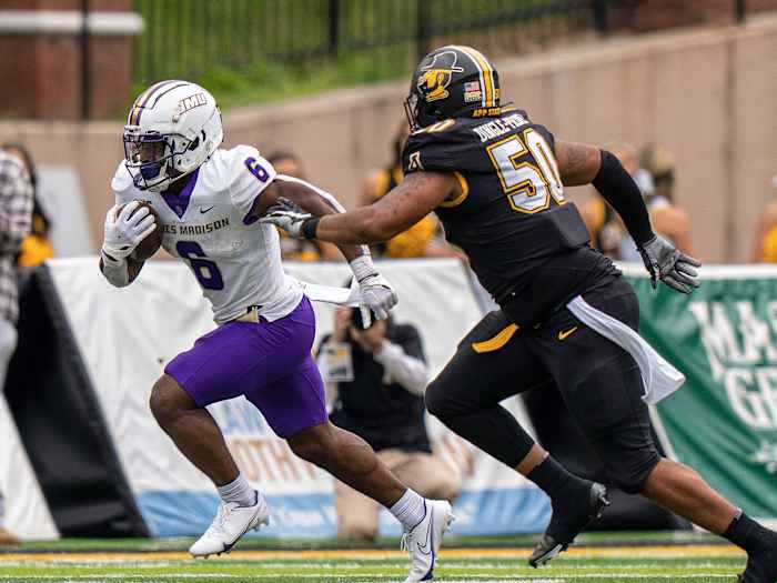 James Madison’s Kaelon Black evades a tackle by App State